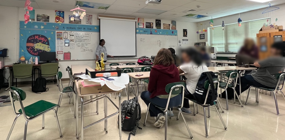Mary teaching a class in front of students