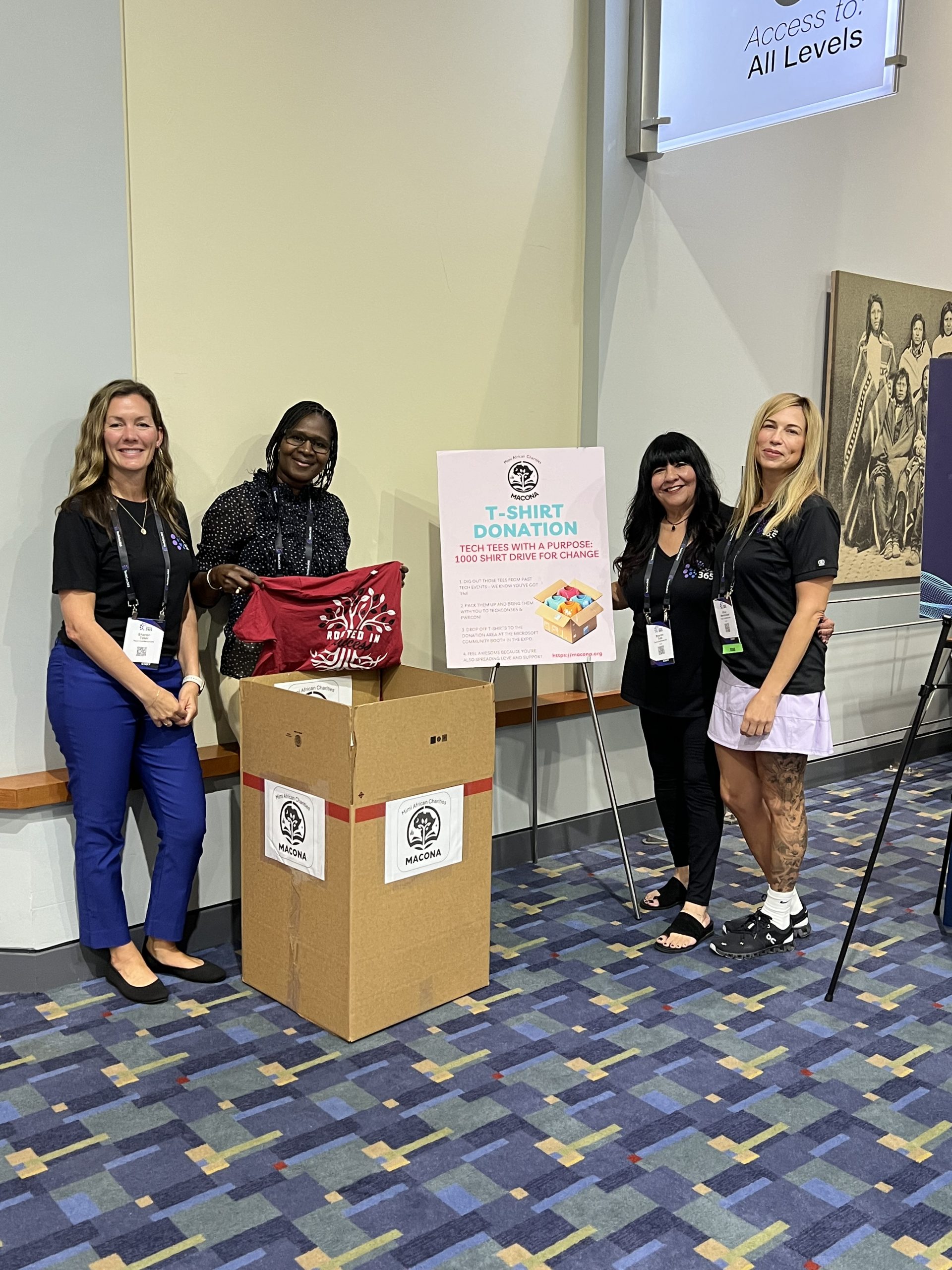 Mimi Williams standing with conference participants at the MACONA donation booth during TechCon 365 in Washington DC