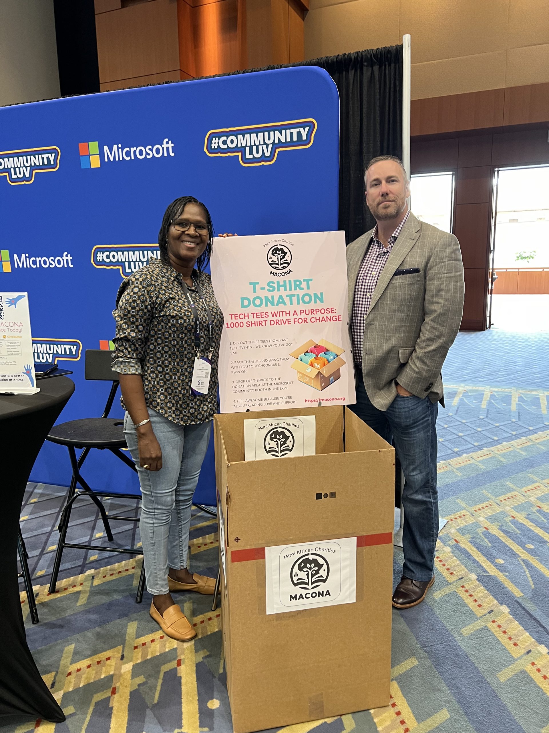 Mimi Williams standing with the TechCon 365 conference organizer next to the MACONA donation box