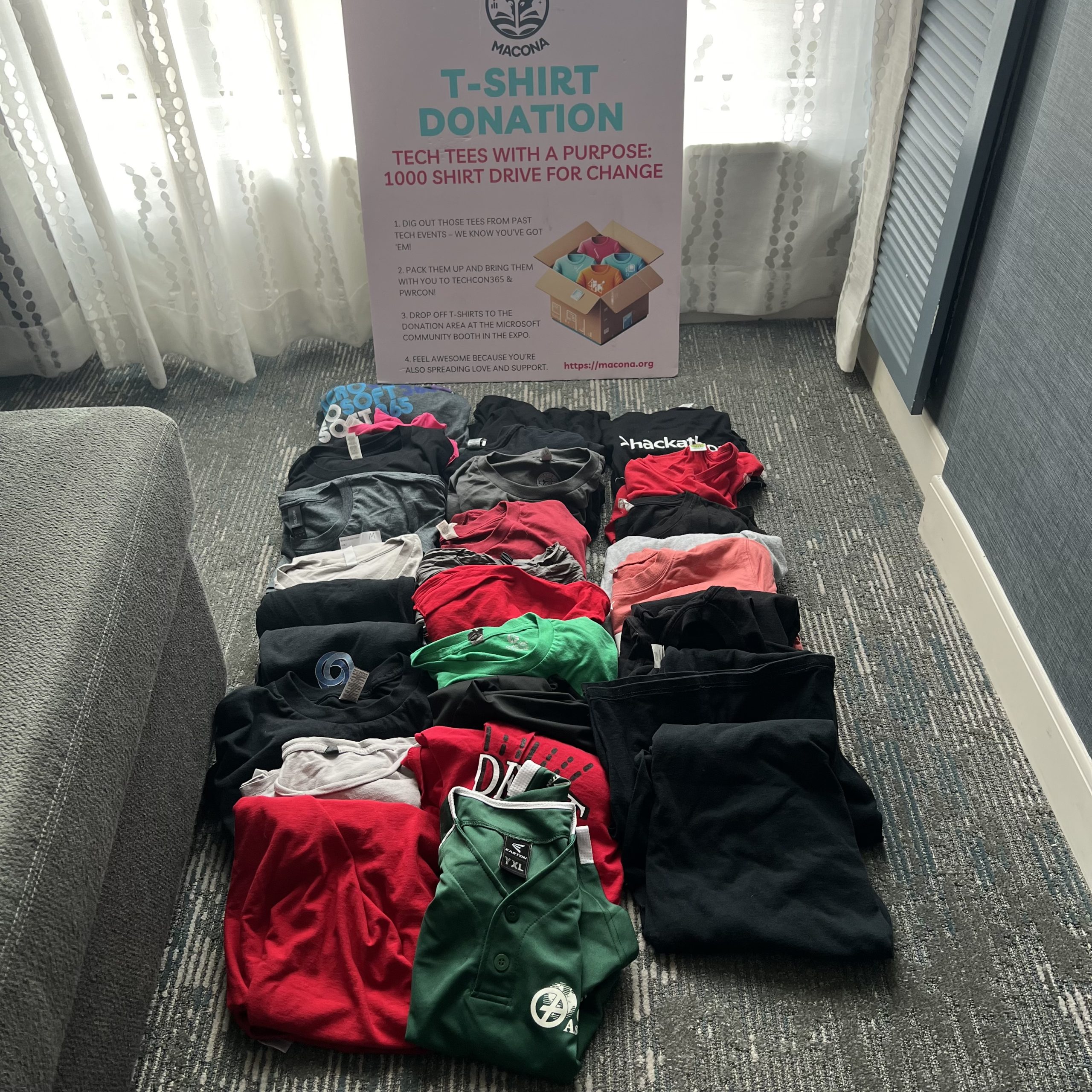 Collection box with donated clothing items inside at the MACONA booth