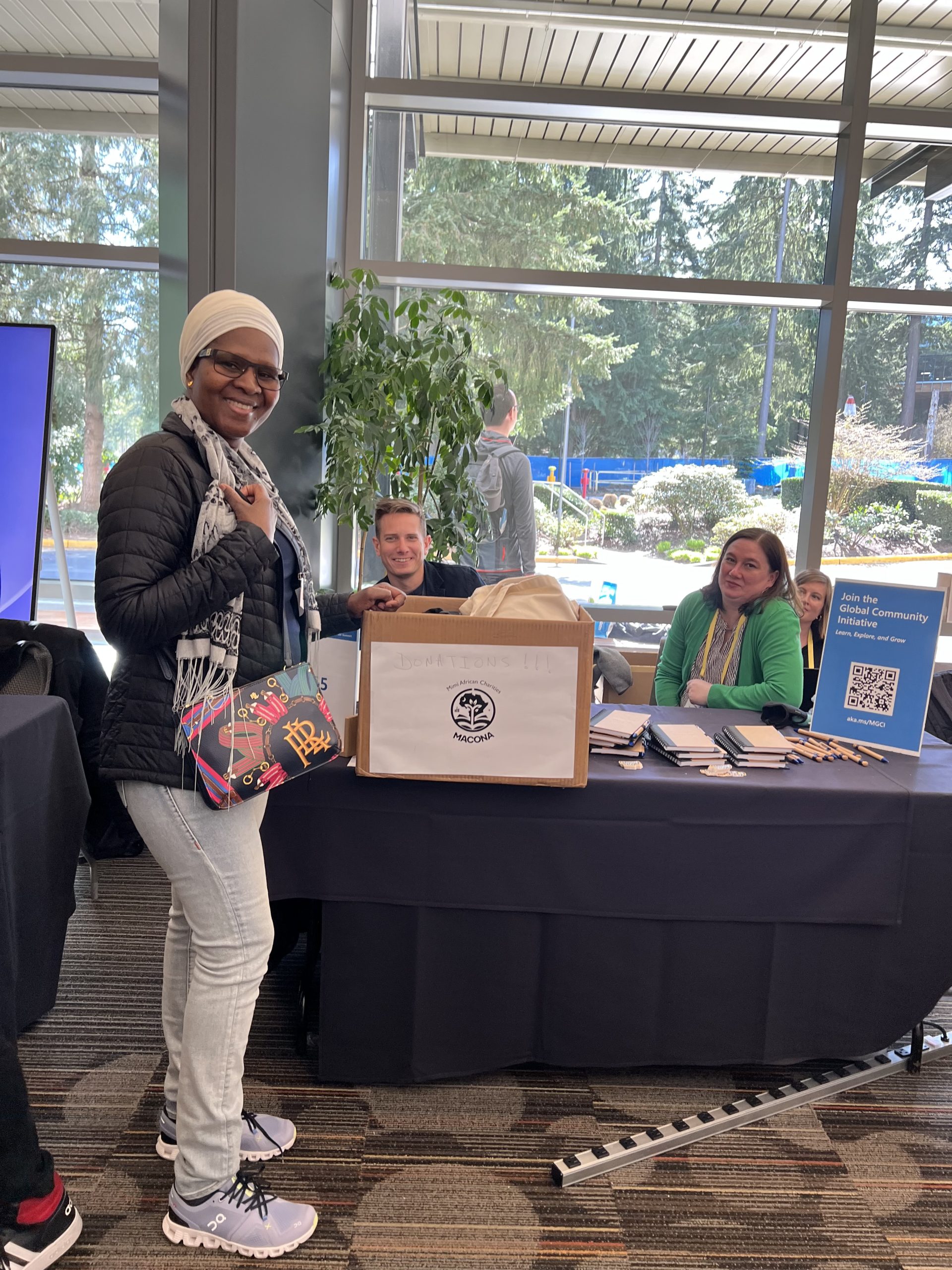 MACONA CEO Mimi Williams at the Microsoft MVP Summit donation table collecting donated shirts