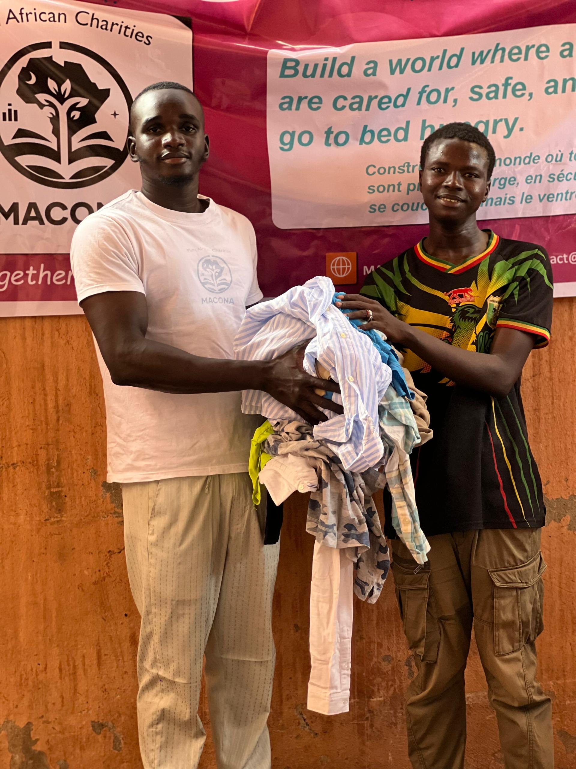 MACONA staff distributing donated clothing to community members