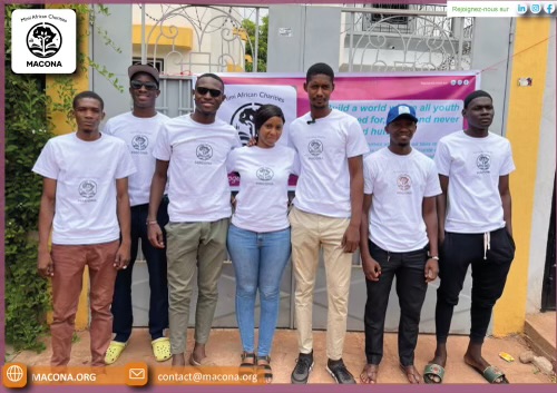 MACONA volunteers in branded shirts lined up in front of the orphanage