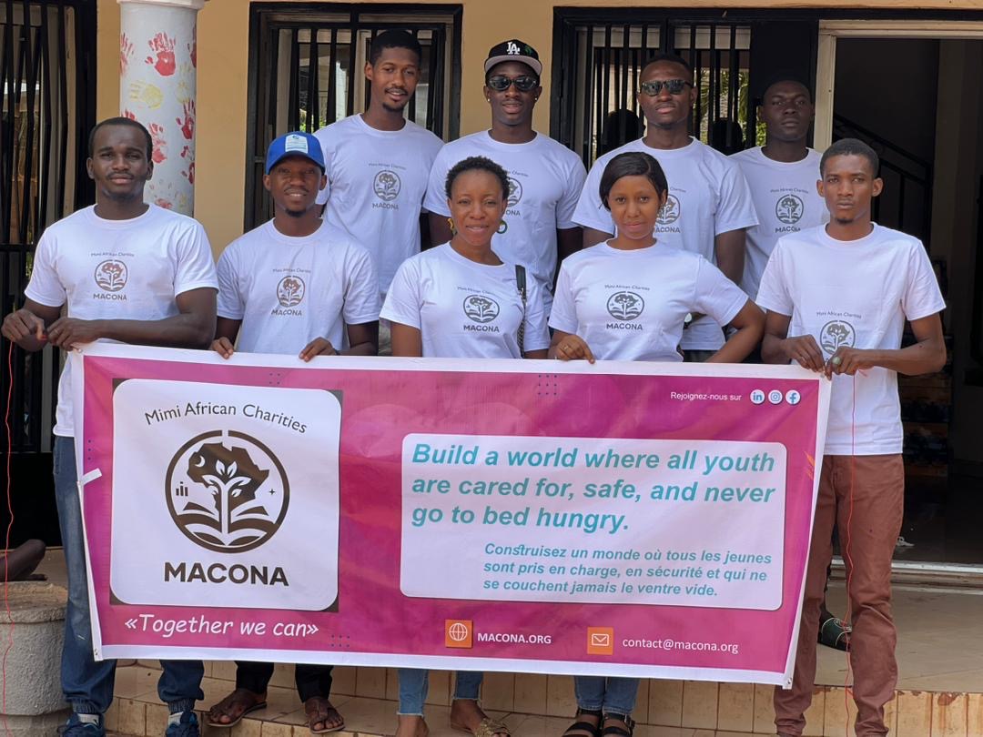 Volunteers holding MACONA banner at the orphanage