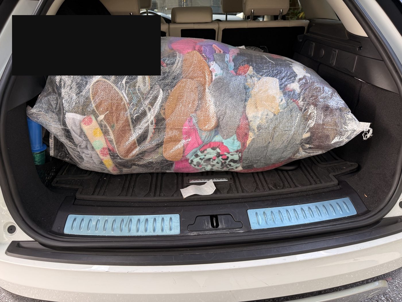 Clear bag of shoes, sneakers, sandals, and clothing loaded for the Summer 2026 shipment to Mali