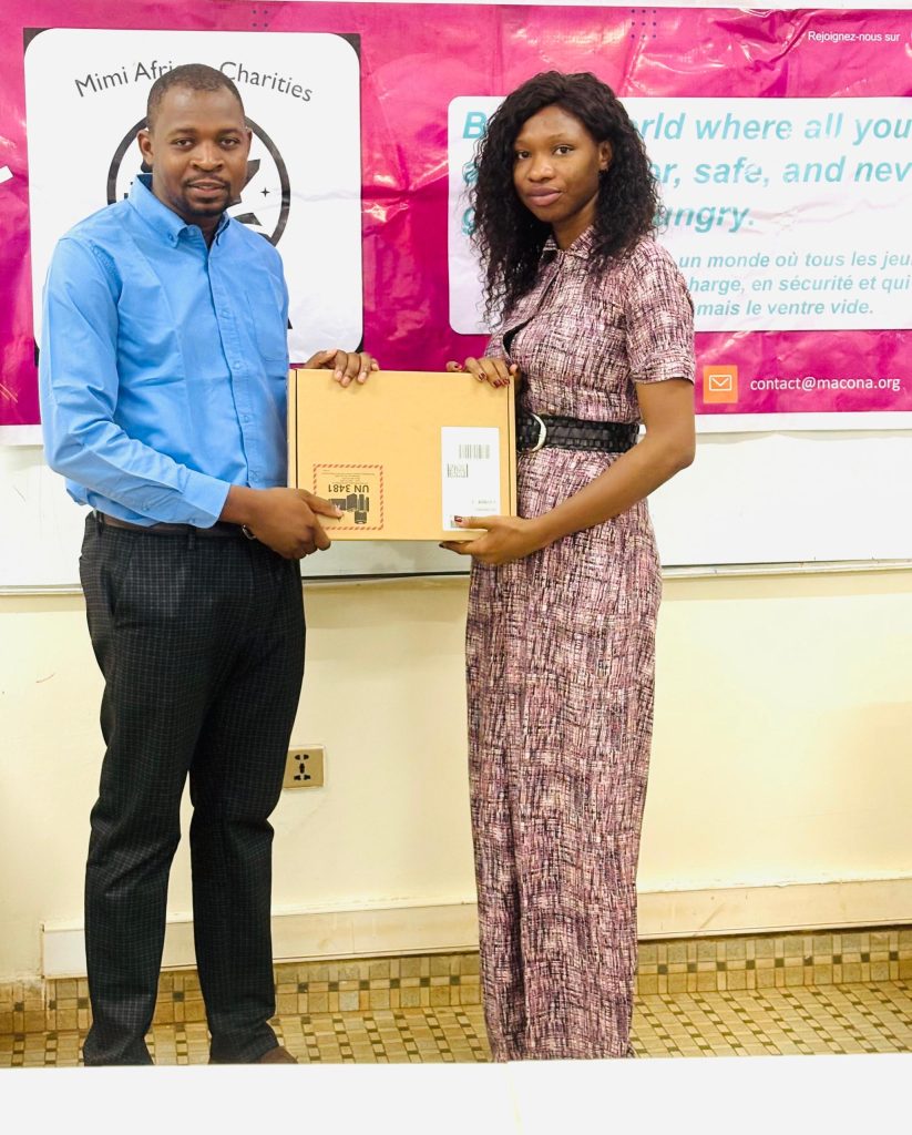 Ceremonial handover of laptop to school representative in Bamako